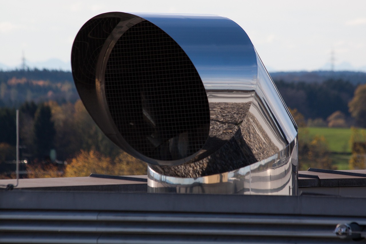 Technician cleaning an air duct vent